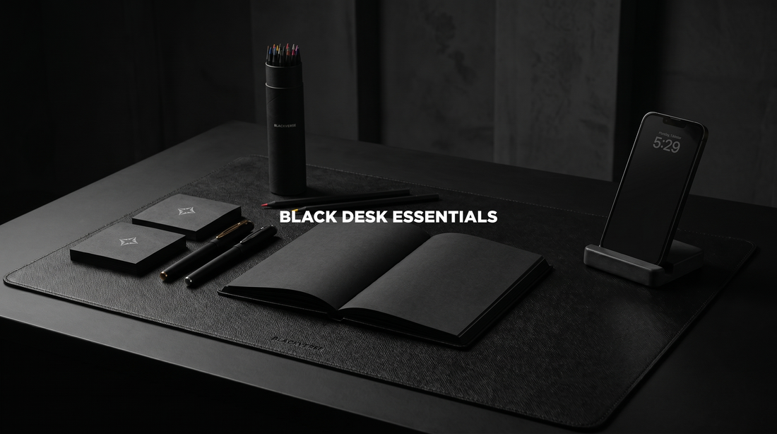 All-black desk setup with leather desk mat, notebook, concrete accessories, and black tumbler