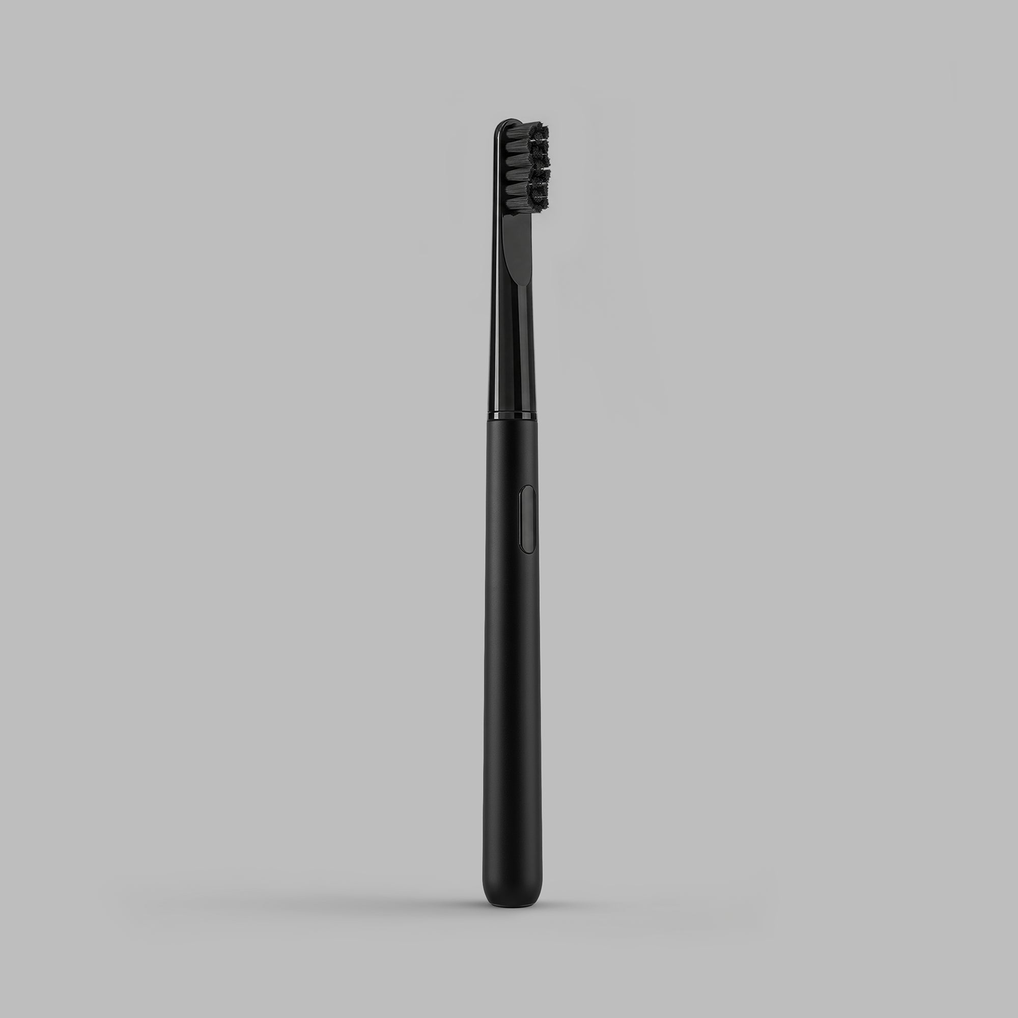 Black sonic toothbrush beside its ribbed travel case, open — BLACKVERSE
