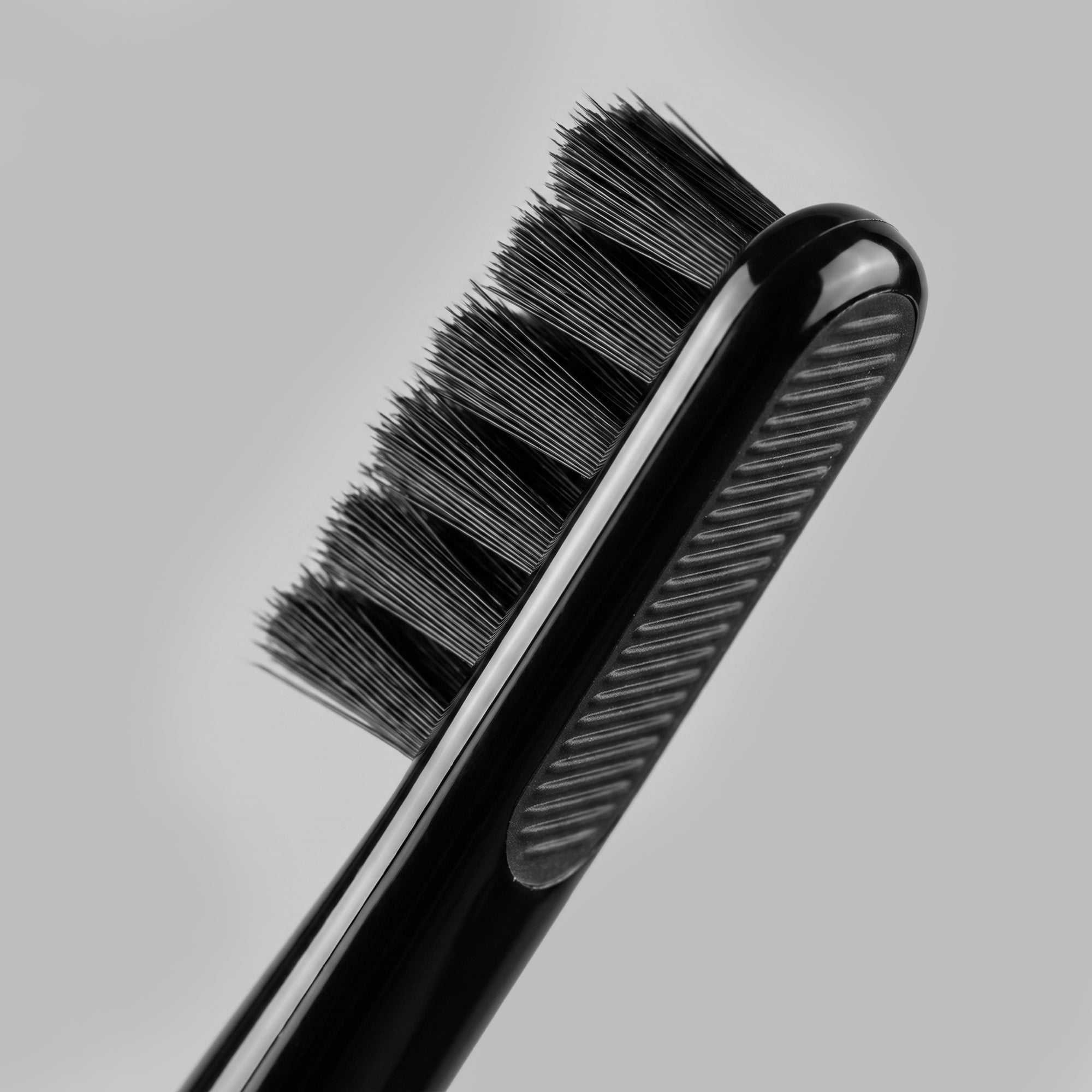 Black toothbrush head, close detail of the soft dark bristles — BLACKVERSE