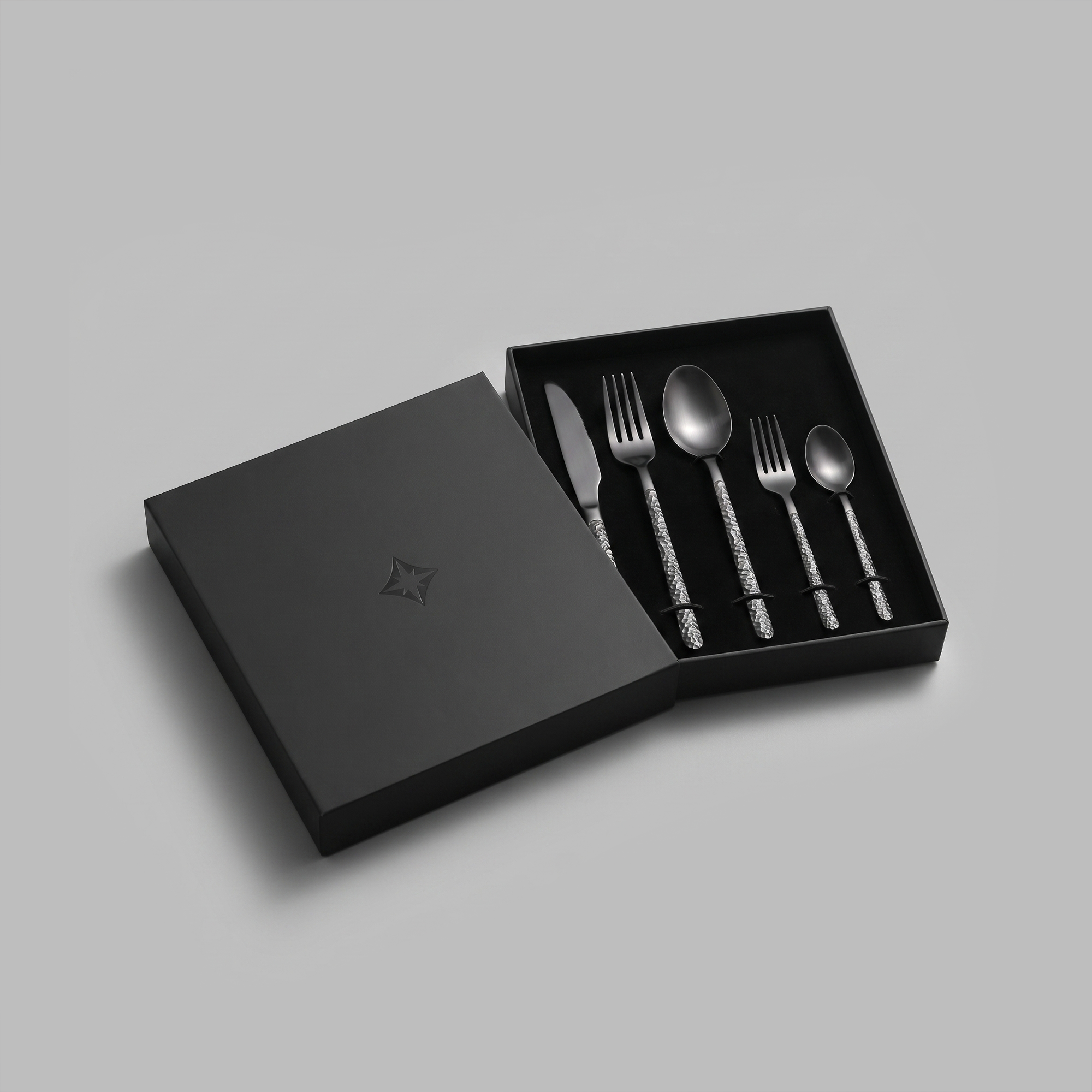 Matte-black Kuro cutlery set, full view of all five pieces — BLACKVERSE