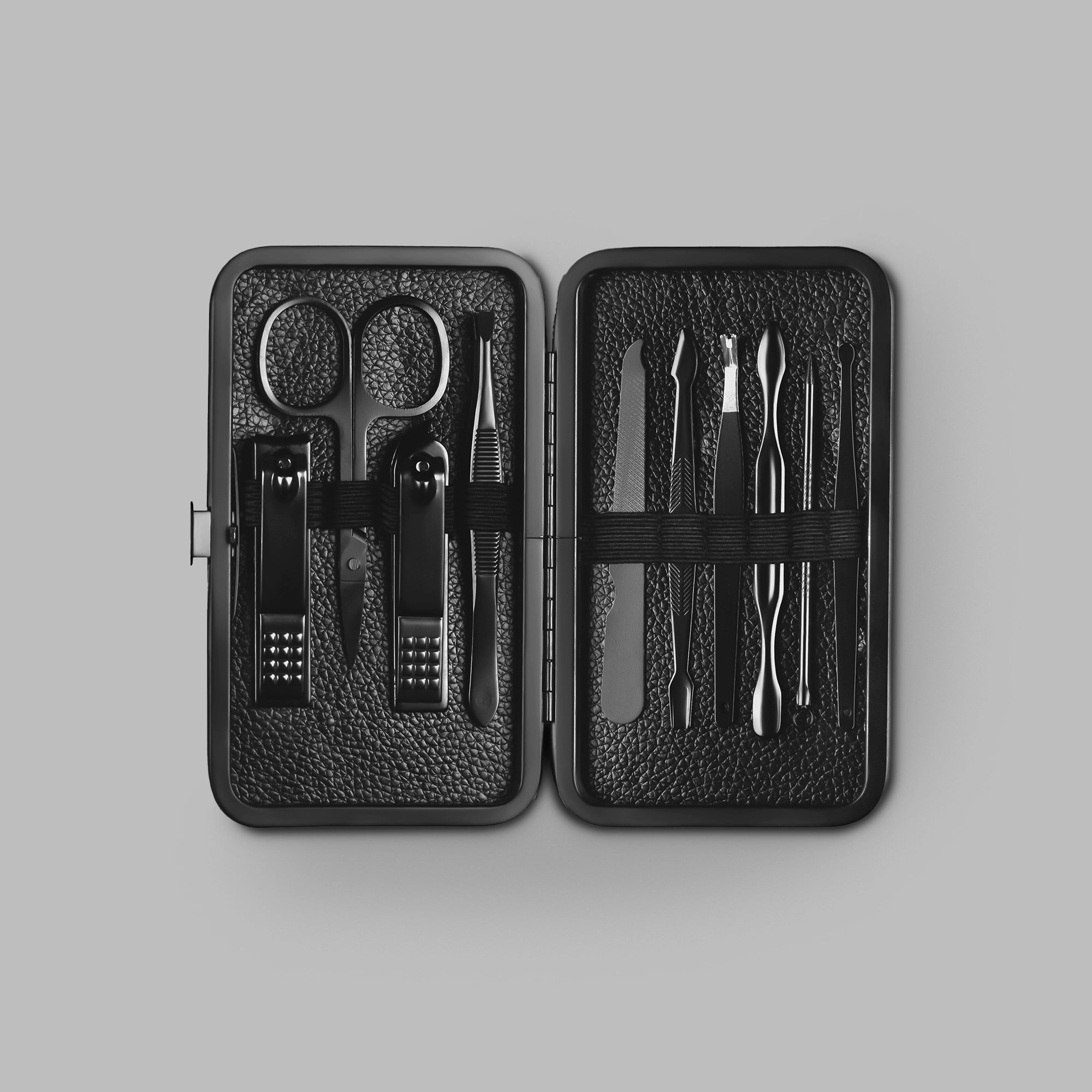 Black grooming kit open to reveal steel manicure tools in a leather case — BLACKVERSE