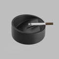 Round black concrete ashtray with a heavy, architectural form — BLACKVERSE