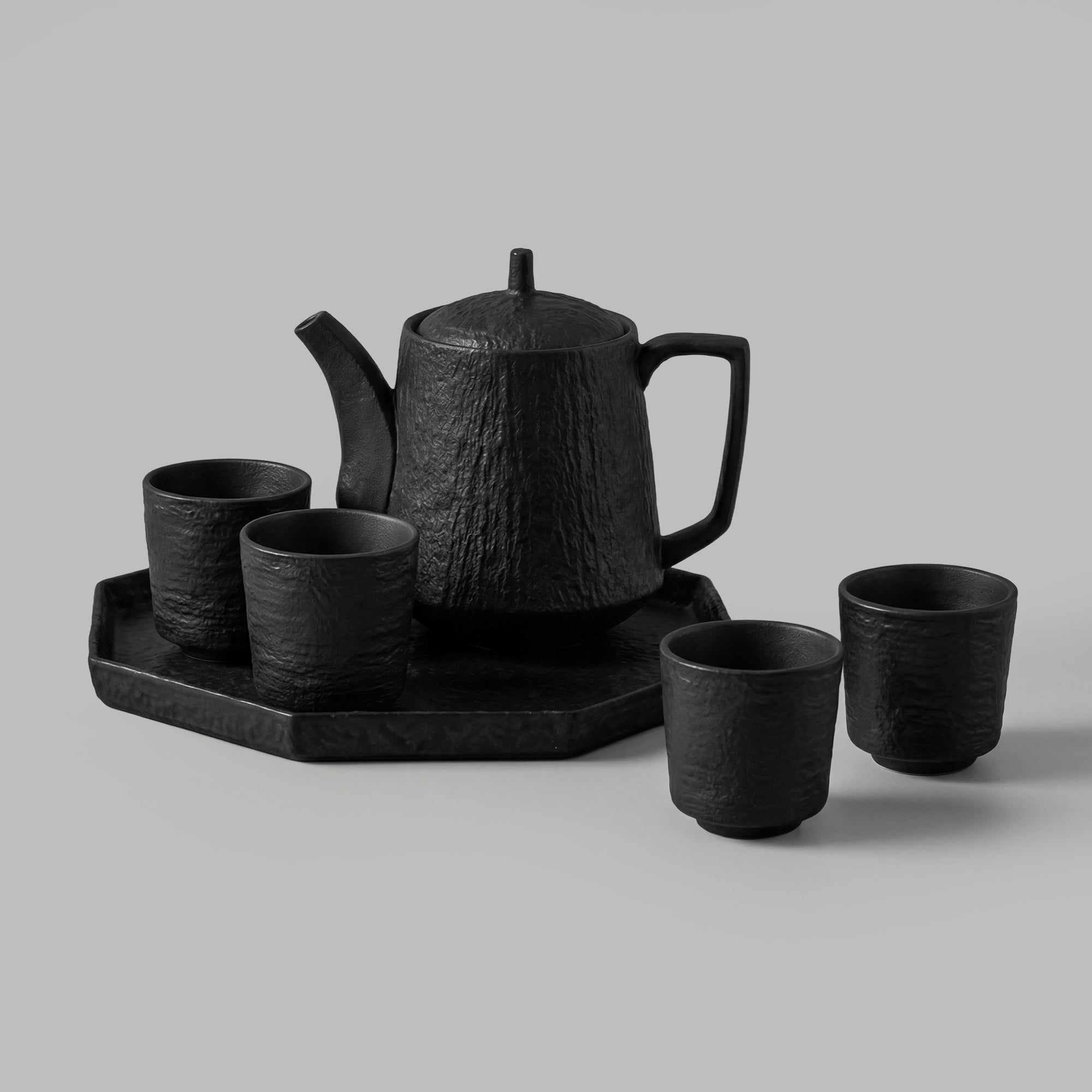 Textured black ceramic tea set with teapot, cups, and tray — BLACKVERSE
